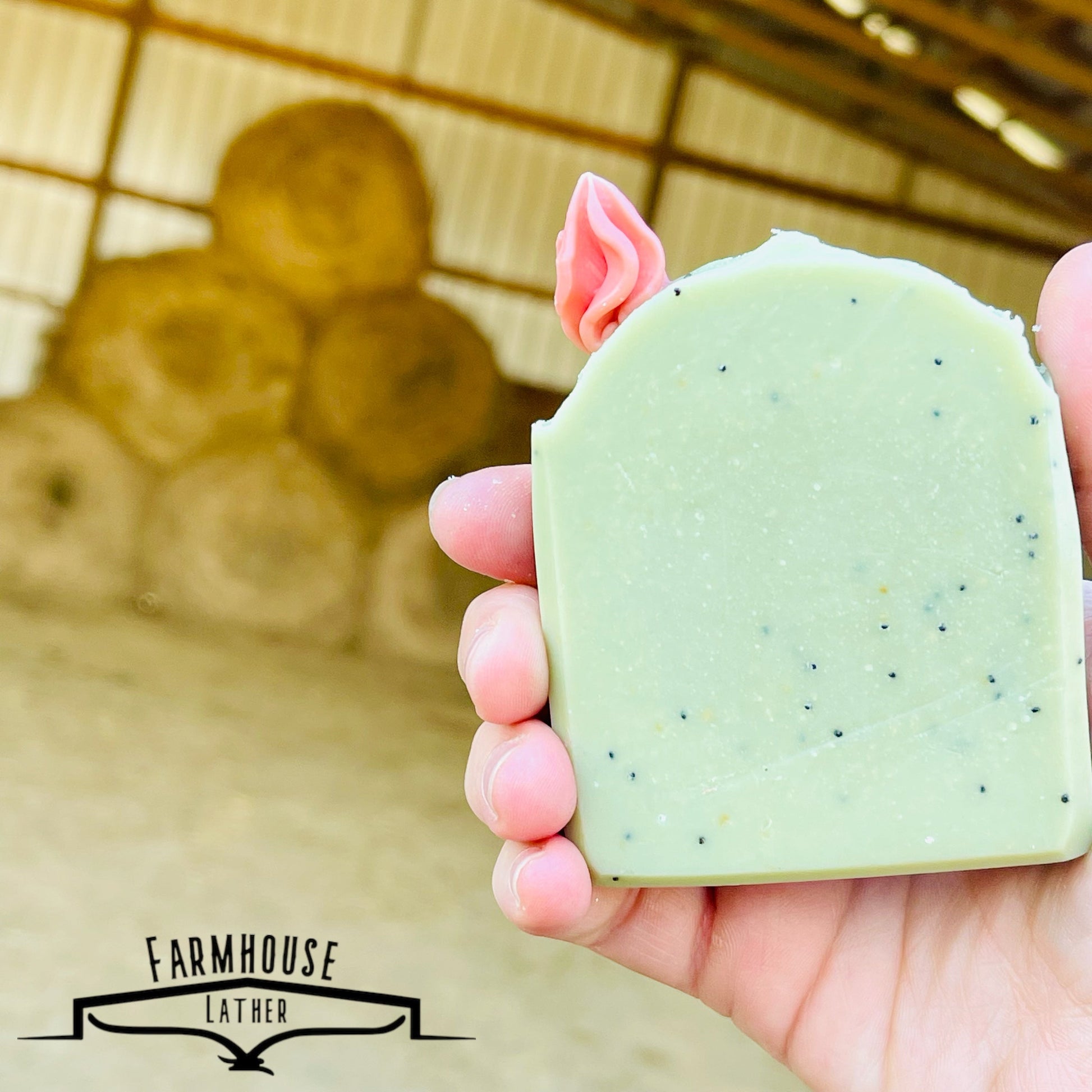 Cactus Blossom bar soap in pale green with pink top flower, held up