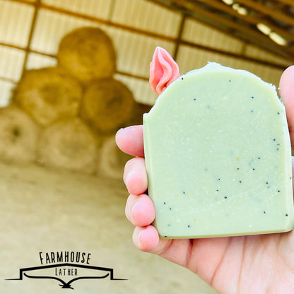 Cactus Blossom bar soap in pale green with pink top flower, held up