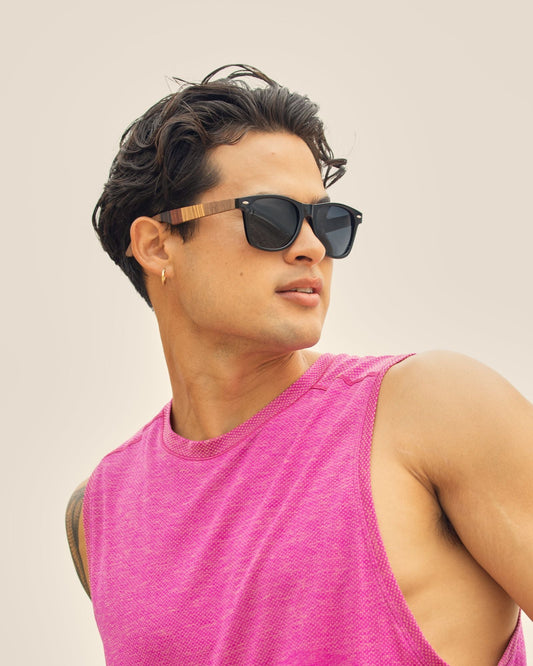 Men's sunglasses with dark lenses, black frame, wood-look temple accents.
