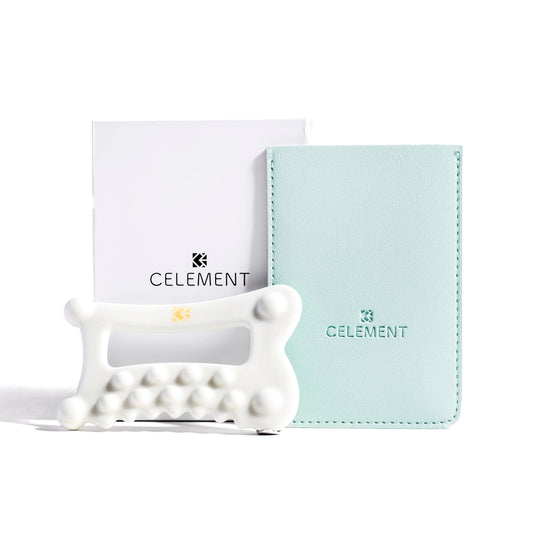 White ceramic gua sha face tool with mint zip pouch and card