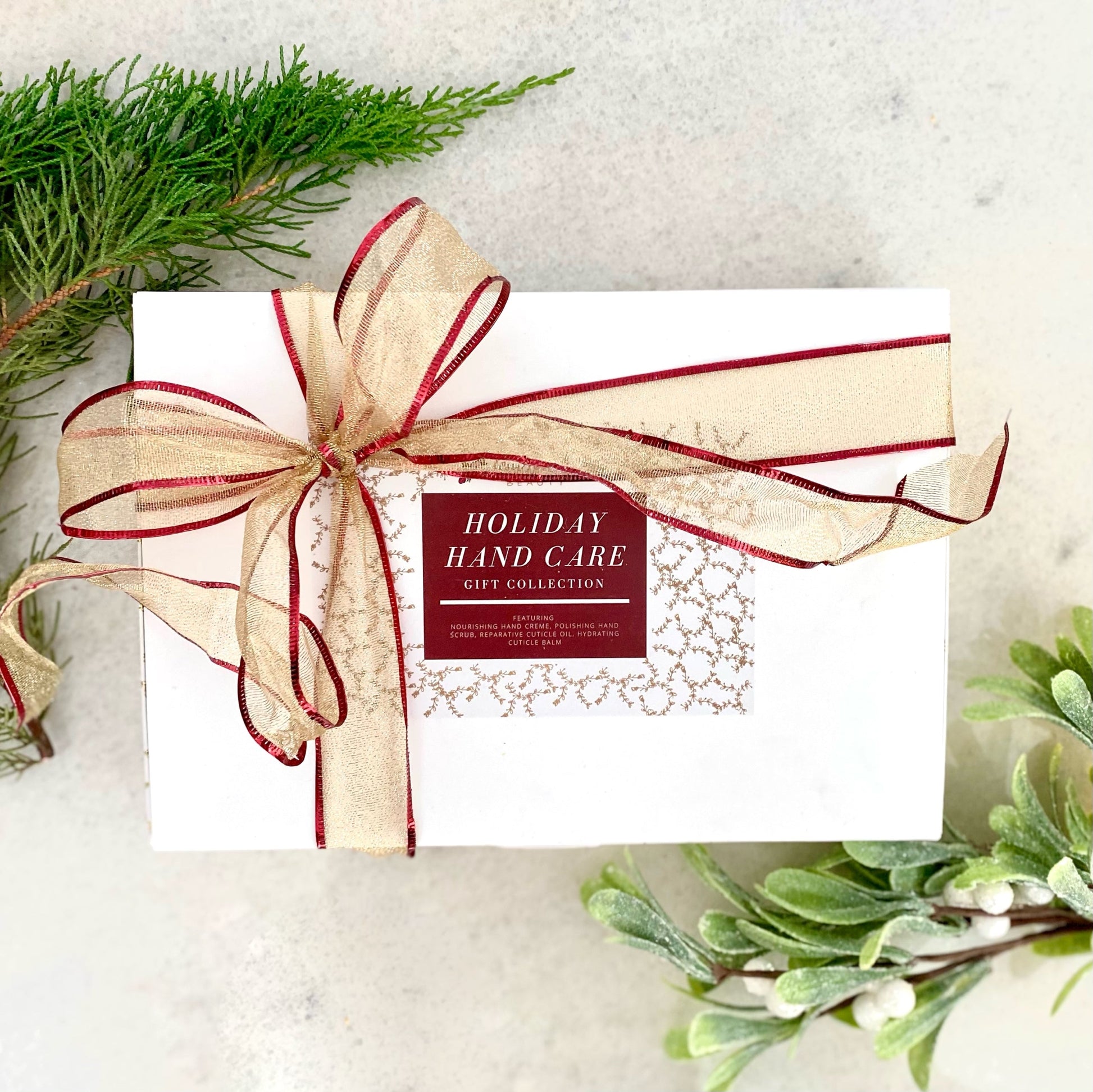 Hand care gift box with ribbon, label reading Holiday Hand Care Gift Collection