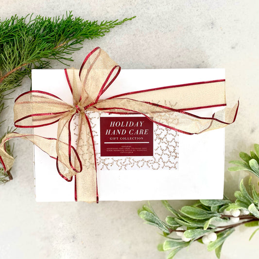 Hand care gift box with ribbon, label reading Holiday Hand Care Gift Collection