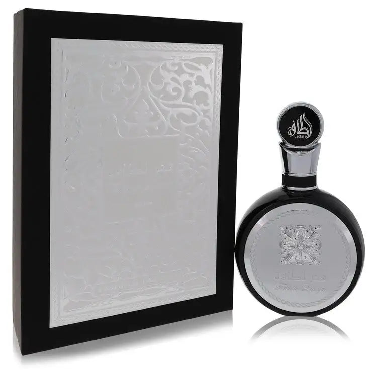 Men's cologne bottle in oval glass with silver cap beside embossed white gift box