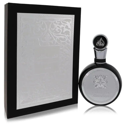 Men's cologne bottle in oval glass with silver cap beside embossed white gift box