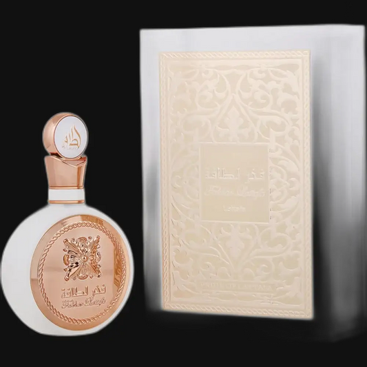 Women’s perfume bottle with rose-gold cap and etched round glass, beside decorative box