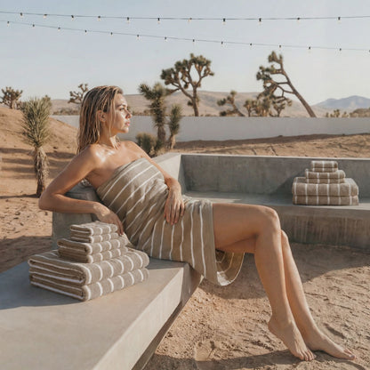 Brown and white striped cotton towel, draped over a bench