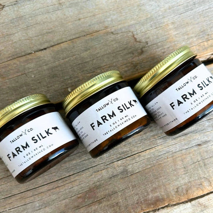 Farm Silk tallow moisturizer jars with green lids and white labels