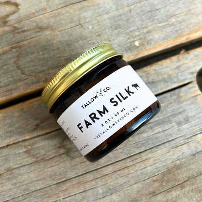 Farm Silk tallow moisturizer jar with green lid and white label