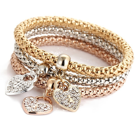 Multicolor rhinestone heart charm bracelet with stacked bangles and gold, silver, rose hearts