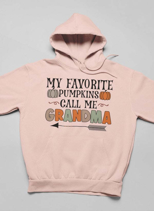 Pink pullover hoodie with hood and front text graphic with pumpkin illustrations.