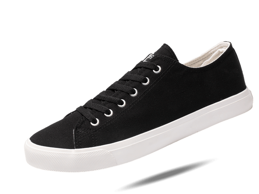 Black canvas low-top sneakers with white rubber sole and lace-up eyelets