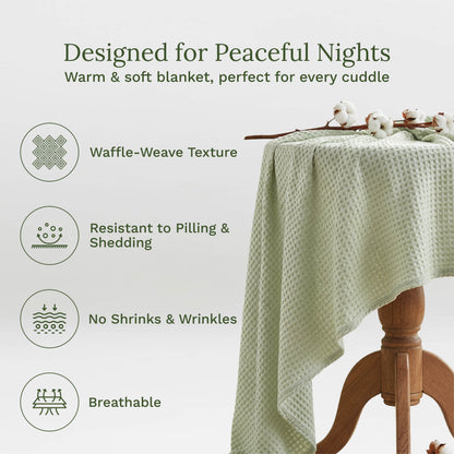Waffle weave blanket, pale green draped over a chair with waffle-weave texture