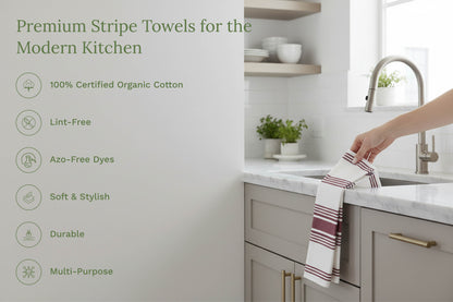 Striped kitchen towels being placed on a countertop, maroon and white stripes