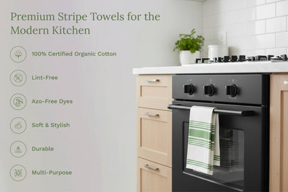 White kitchen towels with teal and green horizontal stripes, hanging on oven door