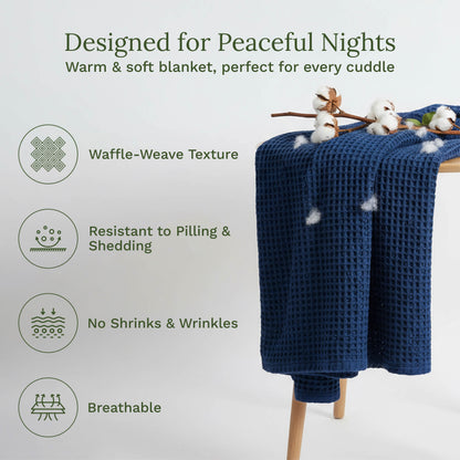 Blue waffle-weave blanket, folded and draped over a wooden stand