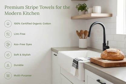 Kitchen towels with black-and-white stripes on a counter beside bread.