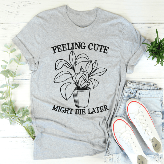 Heather gray crewneck T-shirt, front graphic text “FEELING CUTE” and “MIGHT DIE LATER”