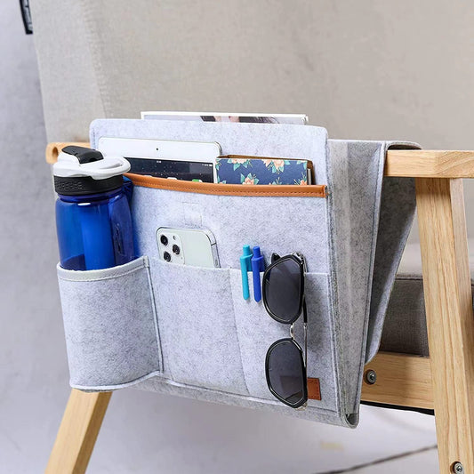 Light gray felt hanging storage organizer with multiple front pockets for phone, pens, and glasses