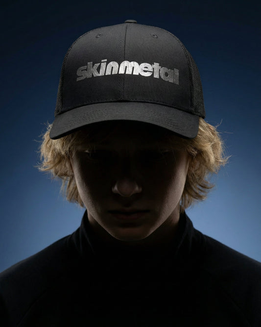 Dark trucker hat with mesh back and front logo patch, curved brim