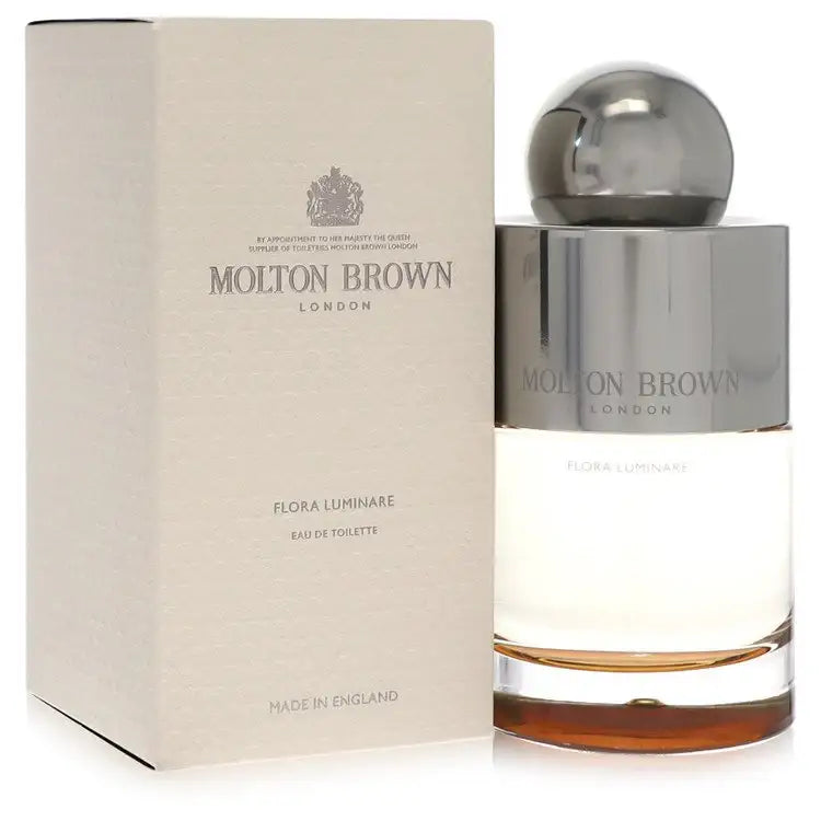 Eau de toilette bottle beside beige carton packaging with chrome cap, Molton Brown.