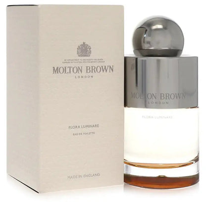 Eau de toilette bottle beside beige carton packaging with chrome cap, Molton Brown.
