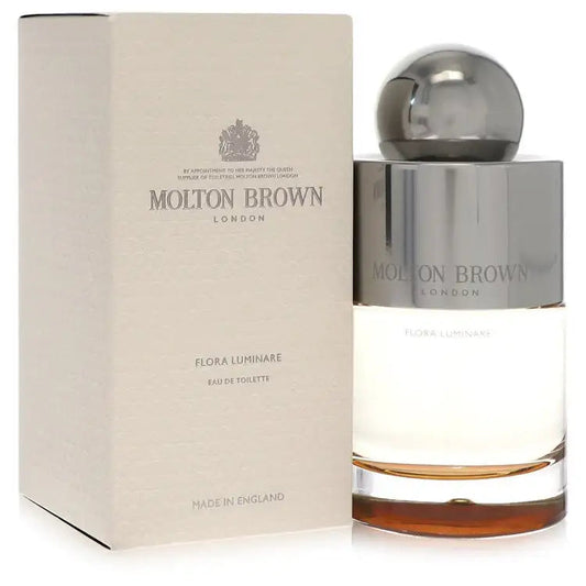 Eau de toilette bottle beside beige carton packaging with chrome cap, Molton Brown.