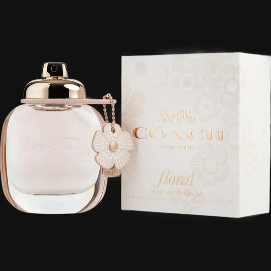COACH Floral Eau de Parfum bottle with rose-gold cap and flower charm, shown beside box