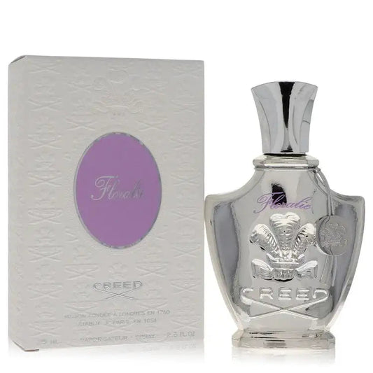 Perfume bottle and light box, both featuring a purple oval label; clear glass.