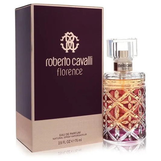 Perfume bottle and burgundy box with gold logo; amber liquid, faceted cap, ornate pattern