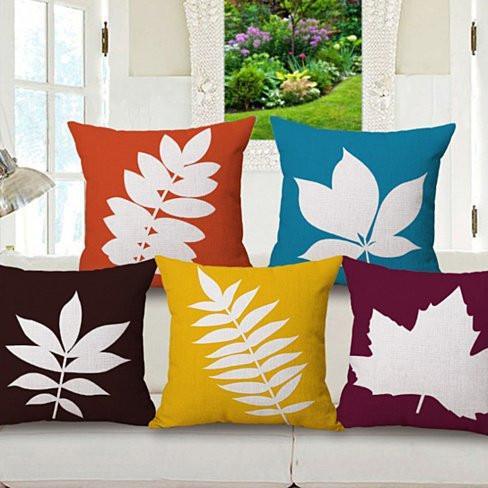 Set of leaf cushion covers with white prints in orange, blue, yellow, and brown