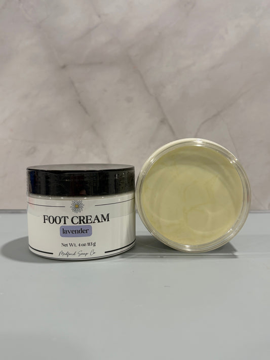 Foot cream jar with black lid, lavender-scented pale yellow cream, closed