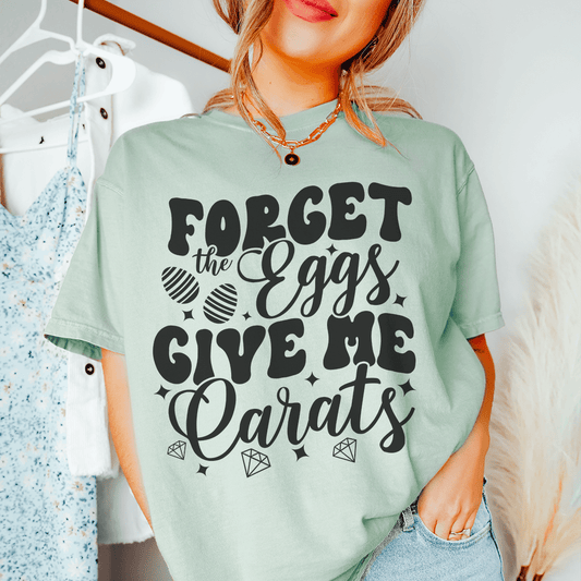 Mint crew-neck T-shirt on model with front graphic text 'Forget the Eggs Give'
