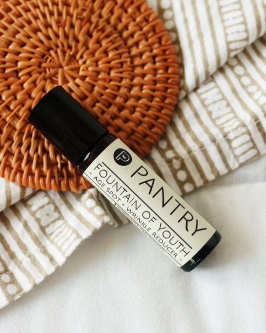 Anti-aging roll-on serum bottle with Fountain of Youth label