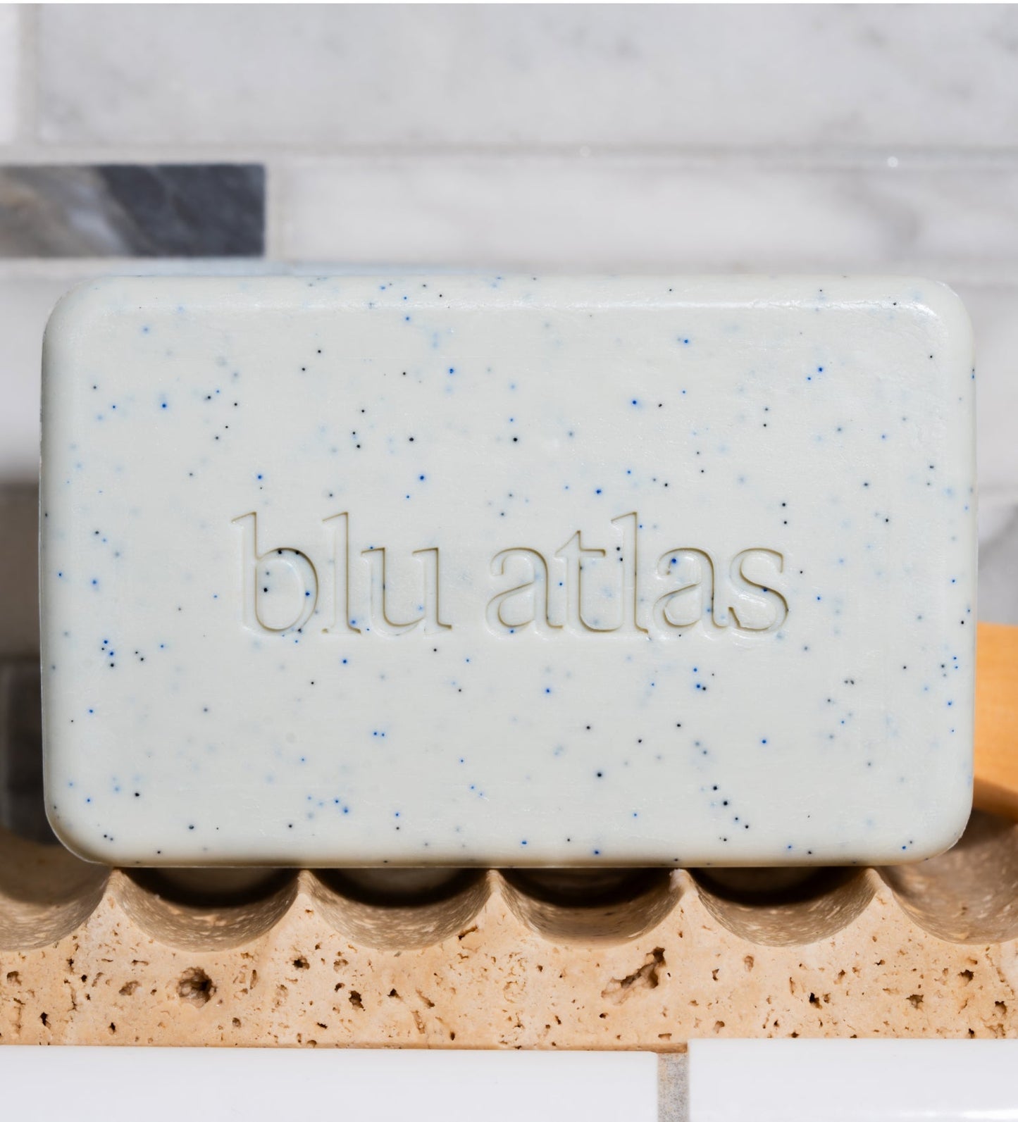 Exfoliating bar soap bar, pale cream with blue specks and blu atlas emboss