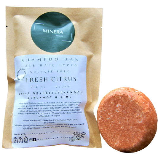 Citrus shampoo bar with brown paper pouch and dark green label