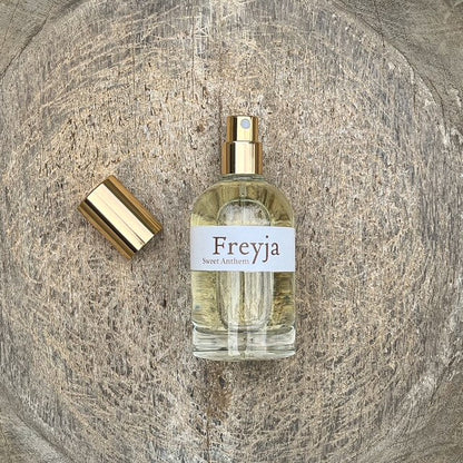 Freyja amber perfume spray bottle with gold cap and clear glass