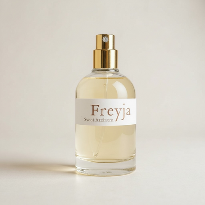 Freyja perfume spray bottle with gold cap and pale amber liquid