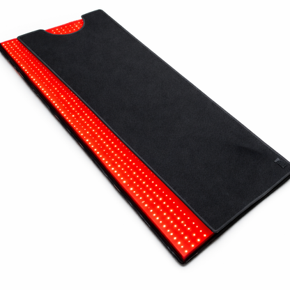 Red LED light therapy mat with black fabric cover and glowing strip edges