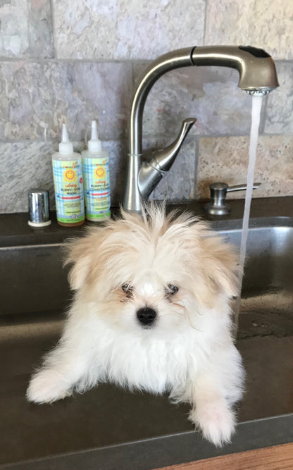 Calming puppy and dog wash and conditioner bottles with pump nozzles on countertop