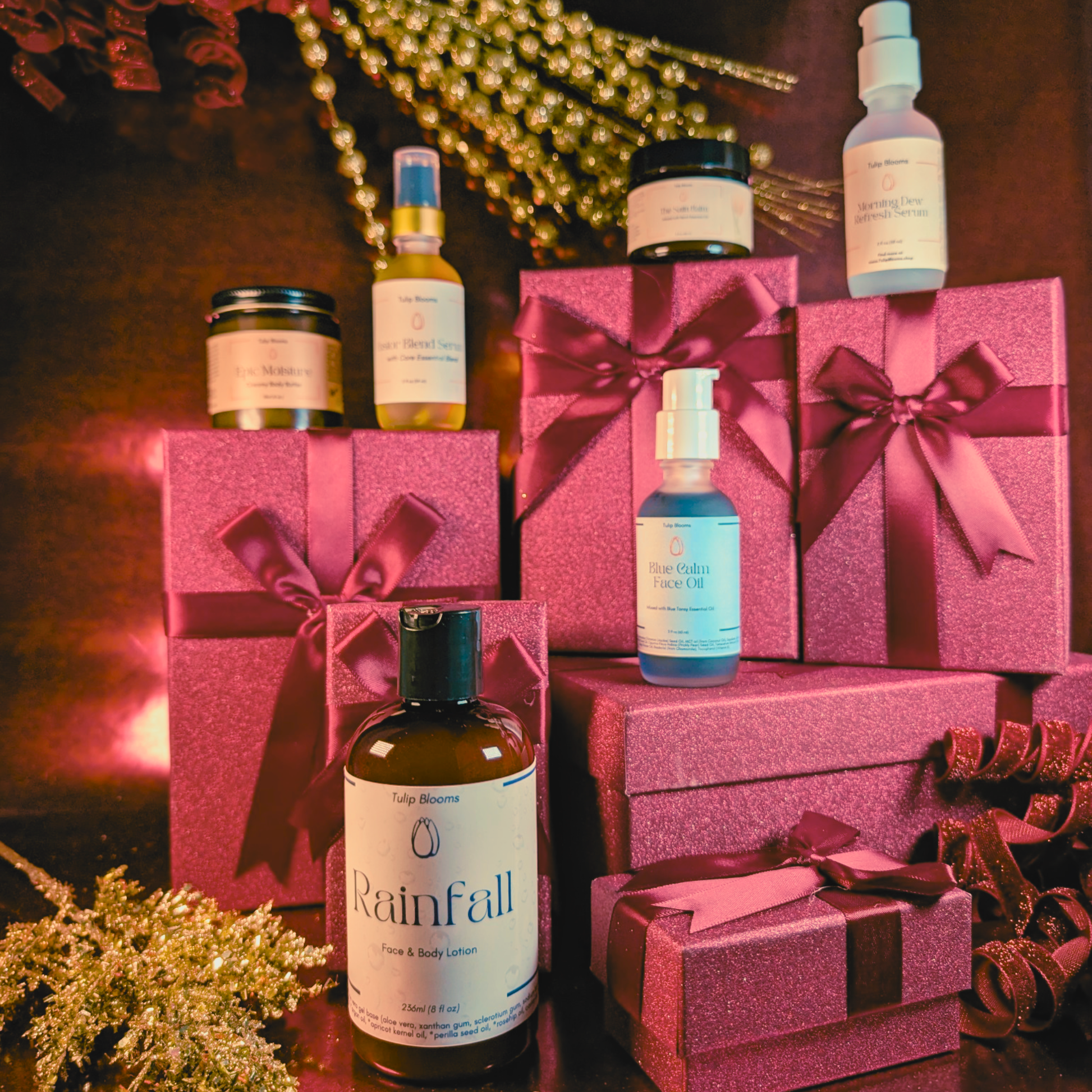Skincare collection set with assorted bottles and jars on pink gift boxes