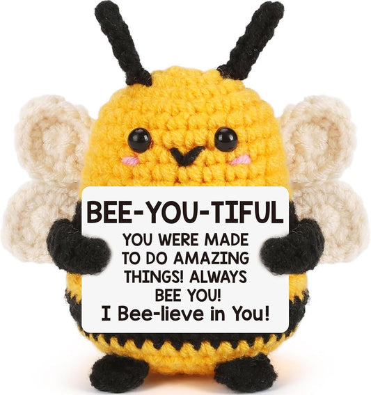 Crocheted yellow bee plush with black stripes, fuzzy antennae, and white wings