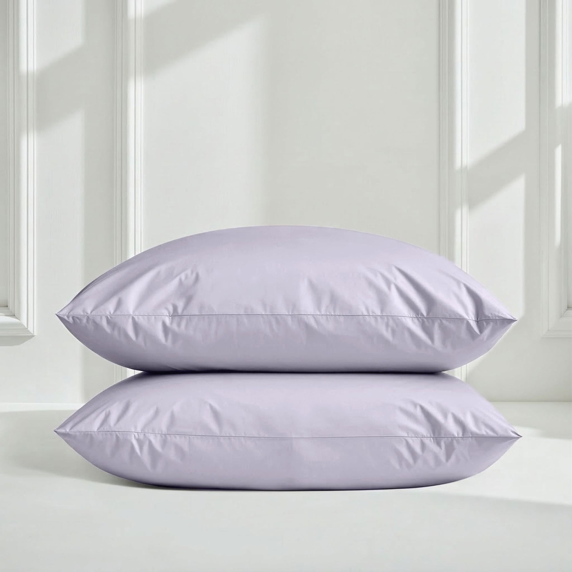 Lavender pillow shams stacked with smooth sateen fabric finish