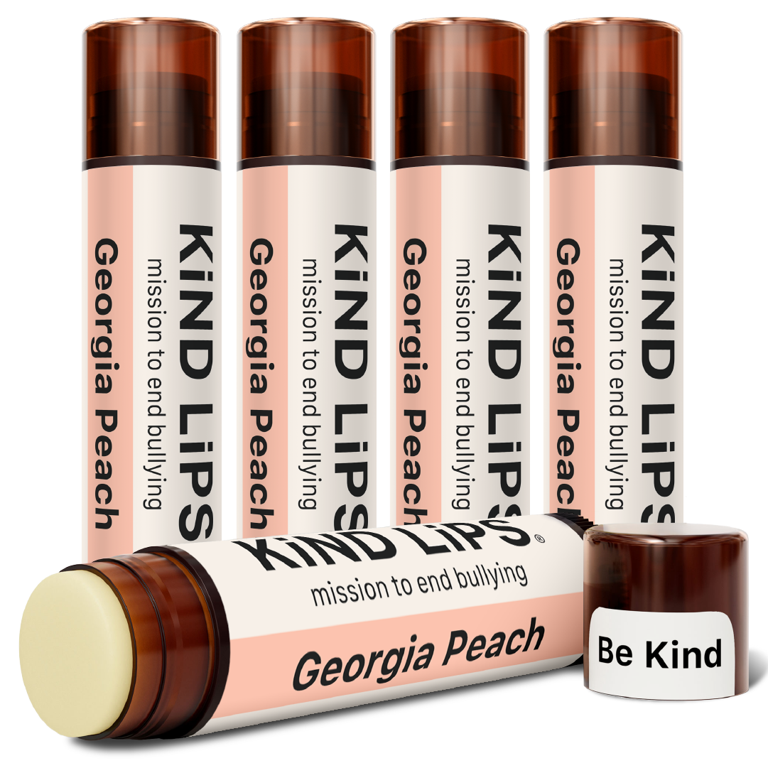 Multiple KIND LIPS lip balm sticks with Georgia Peach tube and capped balm, set view