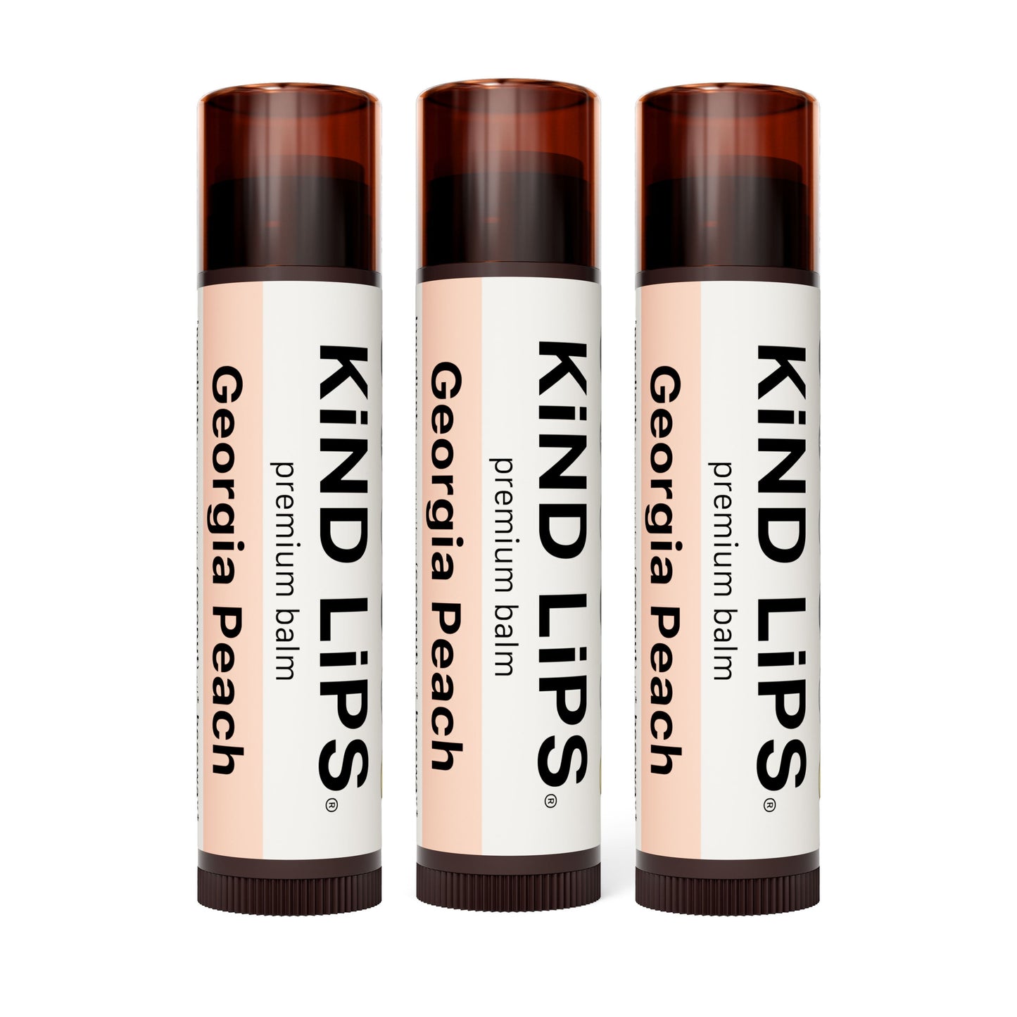 Three KIND LIPS premium lip balm sticks, Georgia Peach labels on dark brown caps