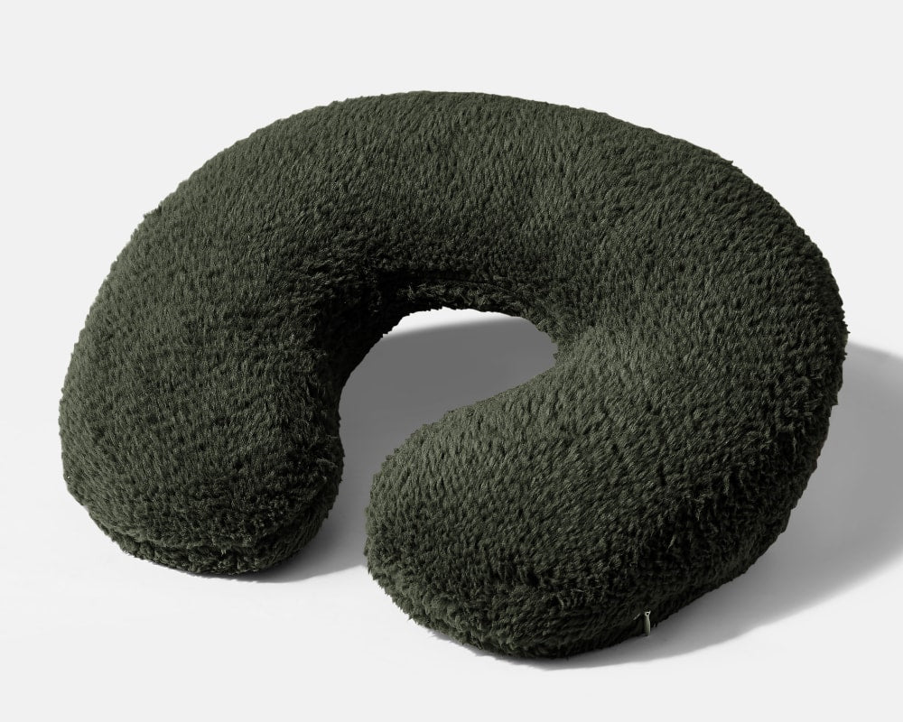 Weighted neck pillow with dark green plush cover and U-shaped design