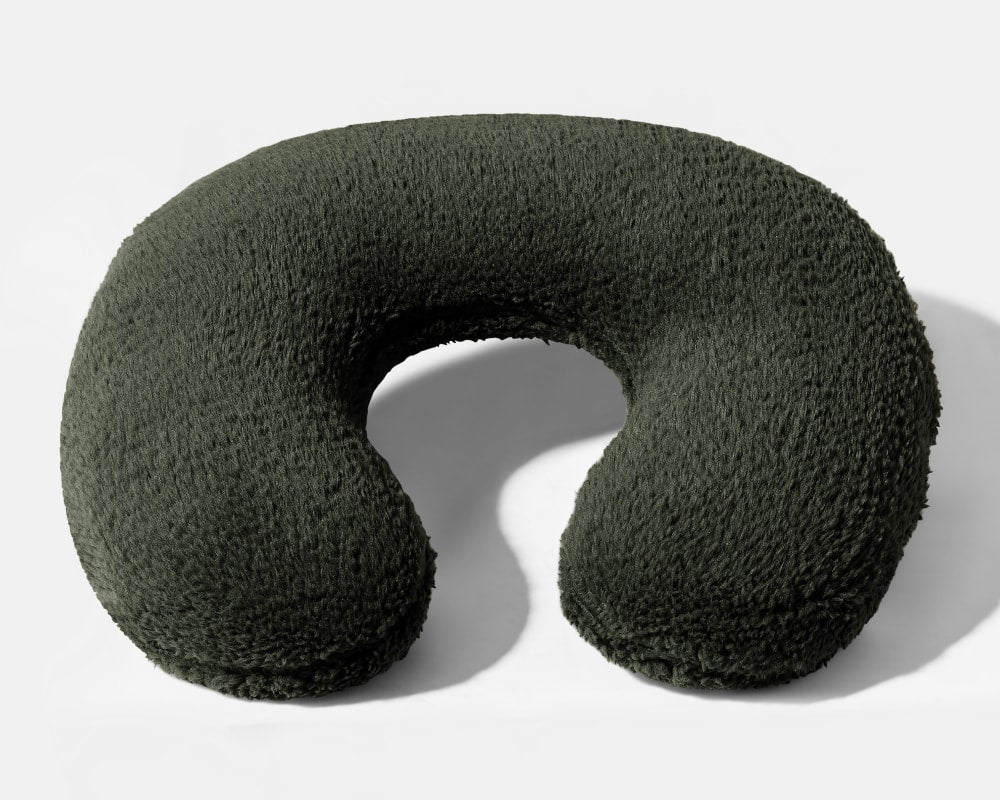 U-shaped weighted neck pillow with dark green plush fabric cover
