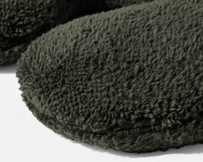 Close-up of dark green plush weighted neck pillow cover and stitched edge