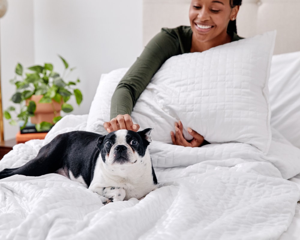 White quilted weighted blanket on bed with folded edge