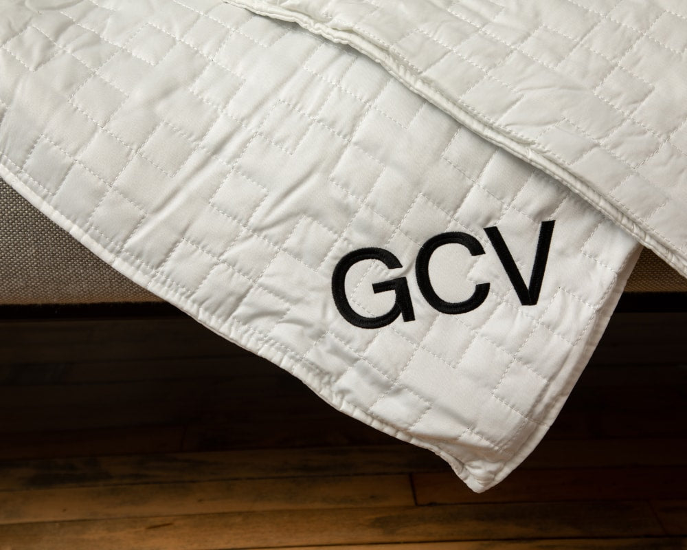 White weighted blanket with GCV logo, quilted stitching