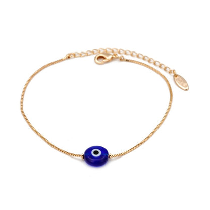 Gold-tone bracelet with a single blue evil-eye bead and lobster clasp